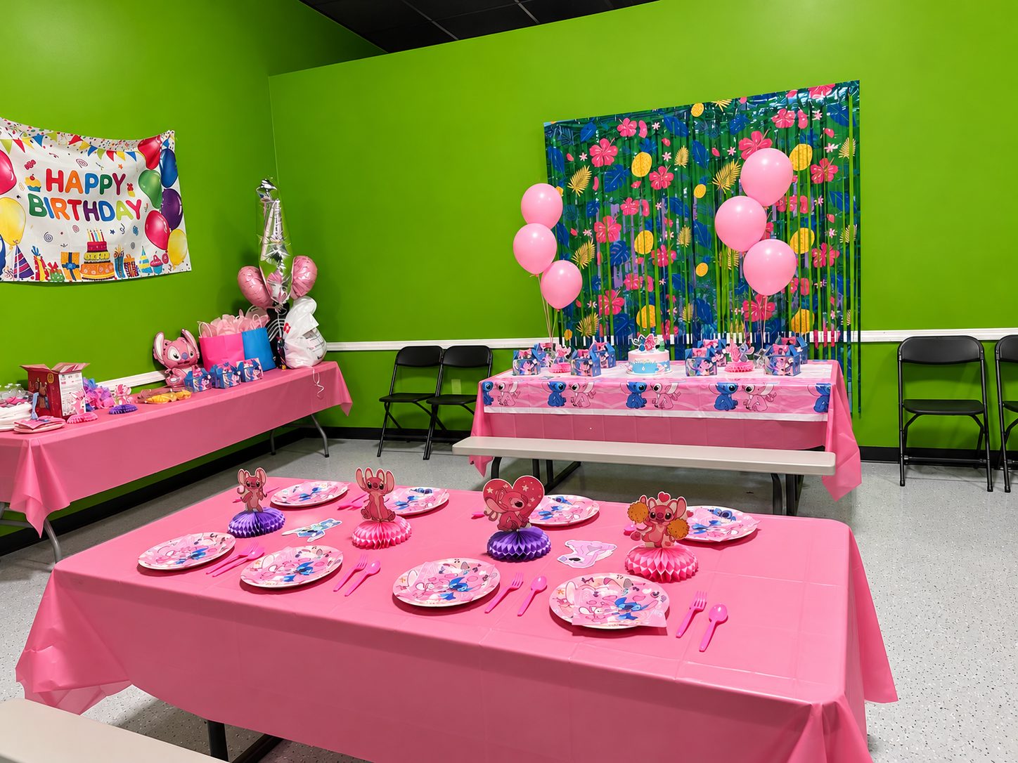 Party room at FunZ Westfield set with pink tables, plates and balloons for a Stitch and Angel birthday